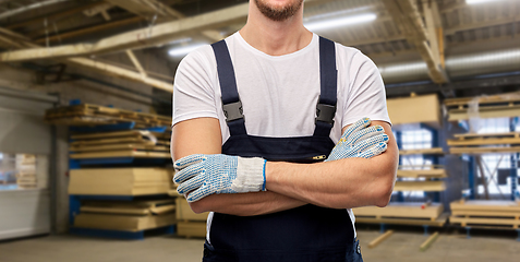 Image showing close up of male builder in overall and gloves