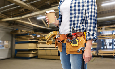 Image showing woman with takeaway coffee cup and working tools