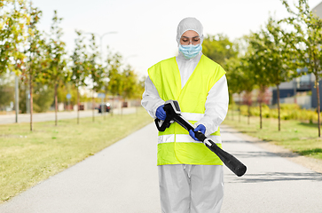 Image showing sanitation worker in hazmat with pressure washer