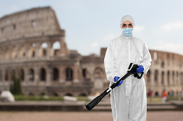 Image showing sanitation worker in hazmat with pressure washer