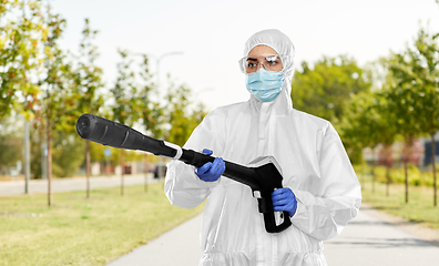 Image showing sanitation worker in hazmat with pressure washer