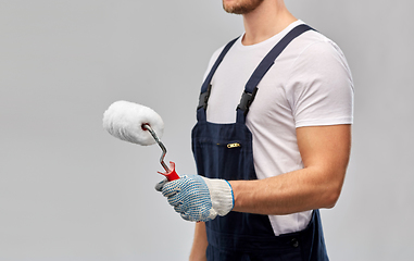 Image showing close up of painter or builder with paint roller