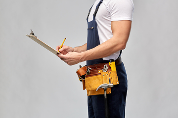 Image showing builder with clipboard, pencil and working tools