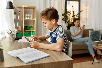 Image showing student boy with tablet computer learning at home