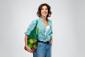 Image showing happy smiling woman with food in reusable net bag