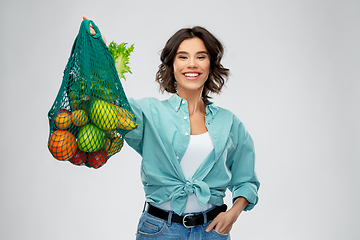 Image showing happy smiling woman with food in reusable net bag