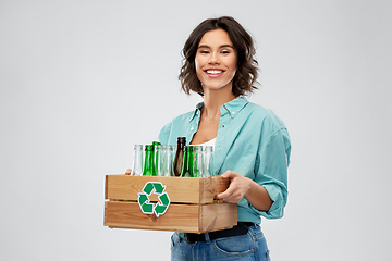 Image showing smiling young woman sorting glass waste