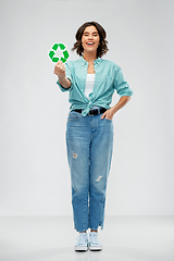 Image showing smiling young woman holding green recycling sign