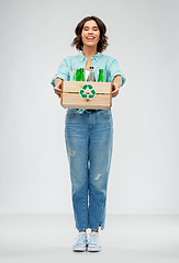 Image showing smiling young woman sorting glass waste