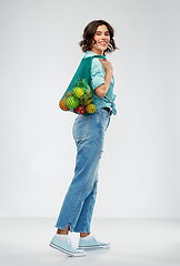 Image showing happy smiling woman with food in reusable net bag