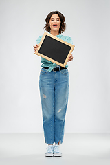 Image showing portrait of smiling woman showing black chalkboard