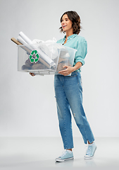 Image showing happy smiling young woman sorting paper waste