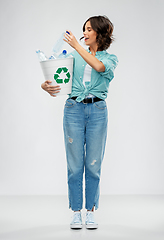 Image showing smiling young woman sorting plastic waste