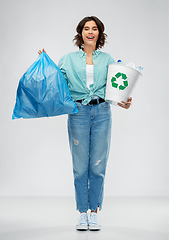 Image showing smiling woman sorting plastic waste and trash bag