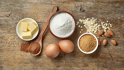 Image showing baking ingredients on wooden table