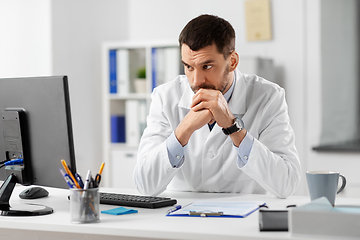 Image showing doctor with clipboard and computer at hospital