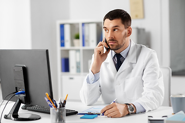 Image showing male doctor calling on phone at hospital