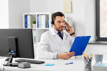 Image showing male doctor with headset and clipboard at hospital