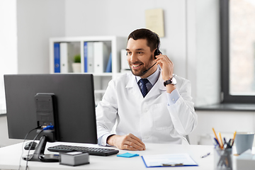 Image showing happy doctor with computer and headset at hospital