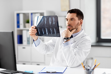 Image showing male doctor with x-ray of spine at hospital