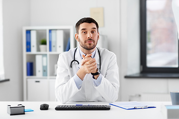 Image showing happy male doctor with stethoscope at hospital