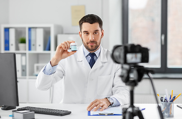 Image showing doctor with drug recording video blog at hospital