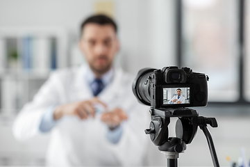 Image showing doctor with hand sanitizer recording video blog