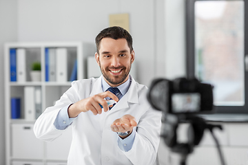 Image showing doctor with hand sanitizer recording video blog