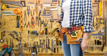 Image showing woman with takeaway coffee cup and working tools