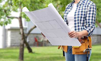 Image showing female builder with blueprint and working tools