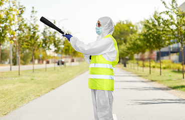 Image showing sanitation worker in hazmat with pressure washer