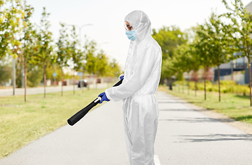 Image showing sanitation worker in hazmat with pressure washer