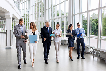 Image showing business people walking along office building