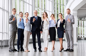 Image showing business people showing ok hand sign at office