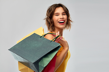 Image showing happy smiling young woman with shopping bags