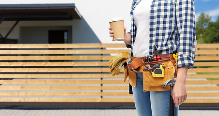 Image showing woman with takeaway coffee cup and working tools