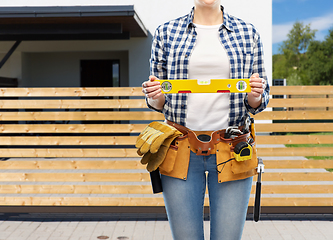 Image showing woman builder with level and working tools on belt