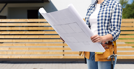 Image showing female builder with blueprint and working tools