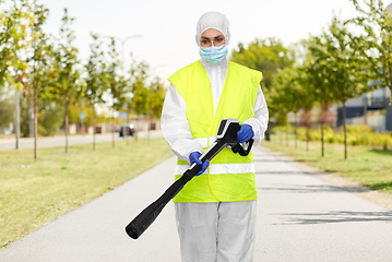 Image showing sanitation worker in hazmat with pressure washer