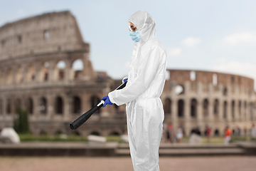 Image showing sanitation worker in hazmat with pressure washer