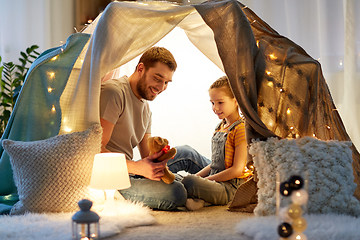 Image showing happy family playing with toy in kids tent at home