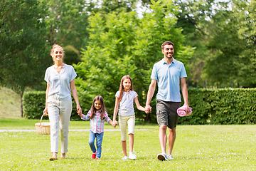 Image showing family with picnic basket walking in summer park