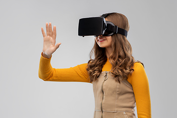 Image showing teenage girl in vr glasses over grey background