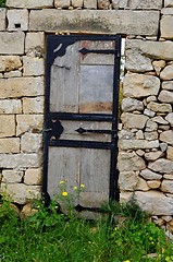 Image showing Wooden door in the ancient stone wall