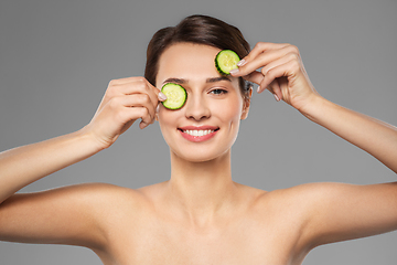 Image showing beautiful woman making eye mask of cucumbers