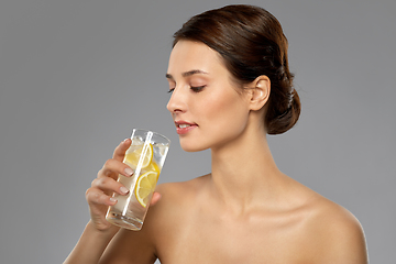 Image showing woman drinking water with lemon and ice