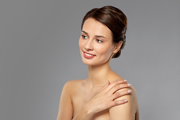 Image showing beautiful young woman touching bare shoulder