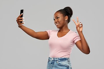 Image showing african american woman taking selfie by smartphone