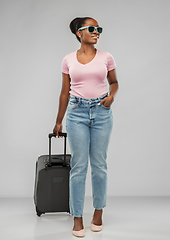 Image showing happy african woman in sunglasses with travel bag