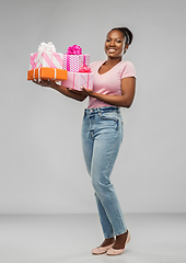 Image showing happy african american woman with gift boxes